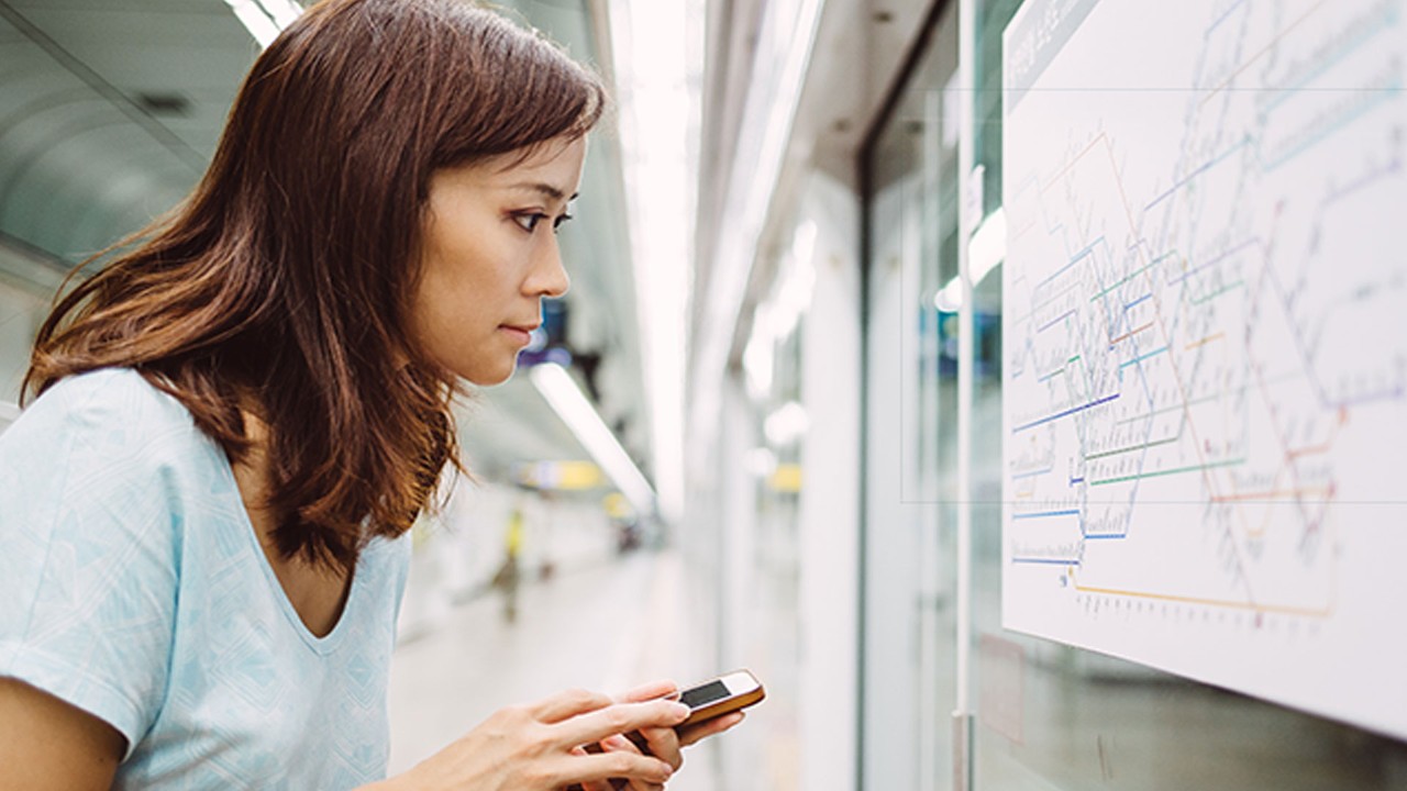 Woman reading subway map