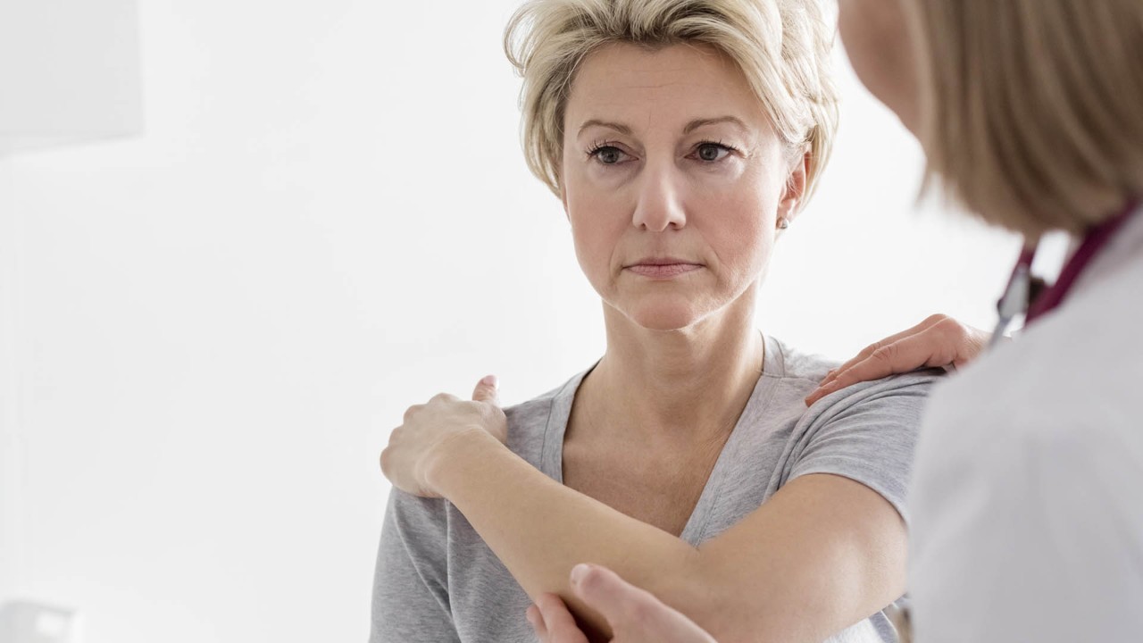 Doctor stretching an MS patient